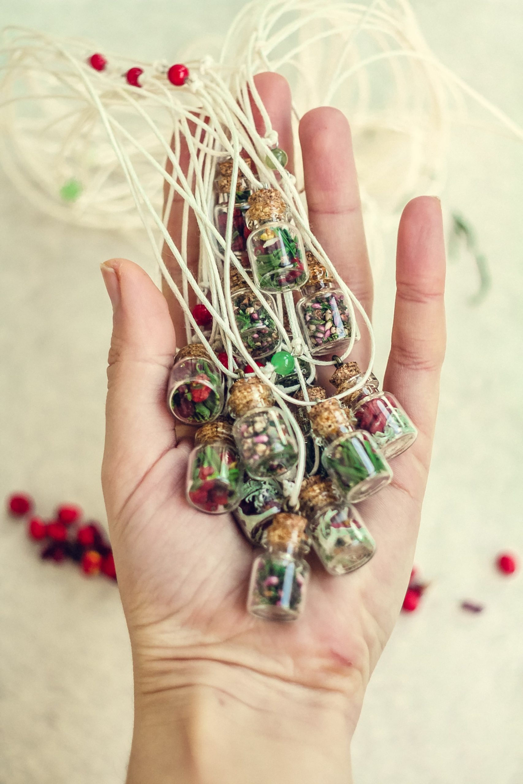 close-up-woman-holding-bottles-with-aromatic-herbs-concept-photo-min